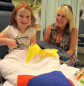 Patient Jemma and her mum, creating artwork during a bedside visit. Image: Mark Zimmerman